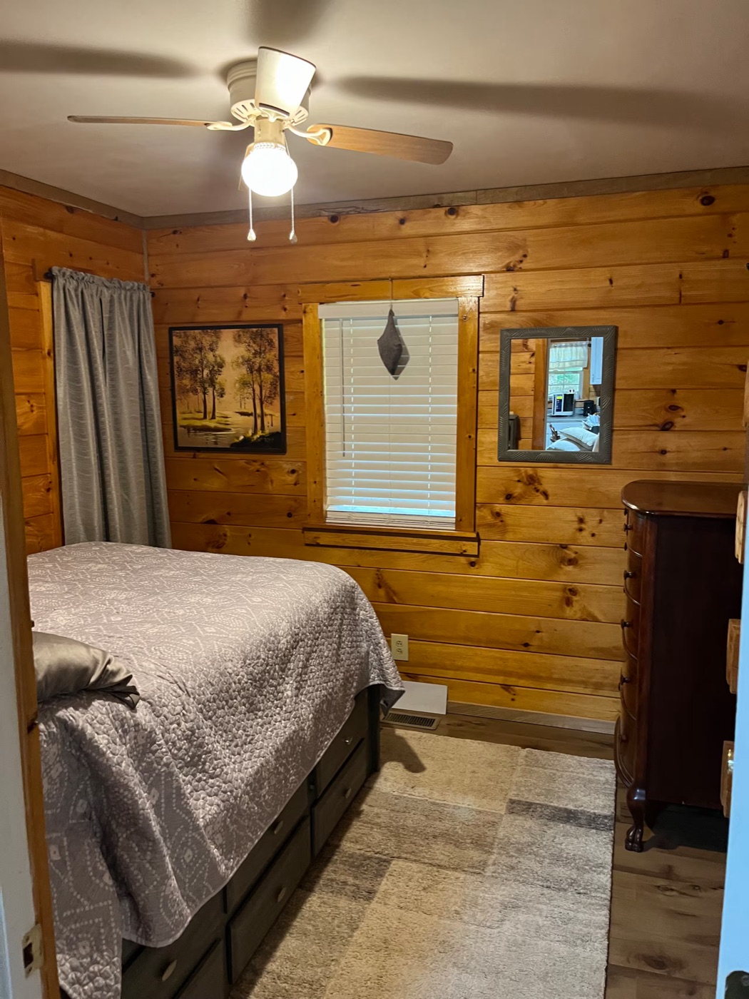 Second bedroom with dresser and mirror